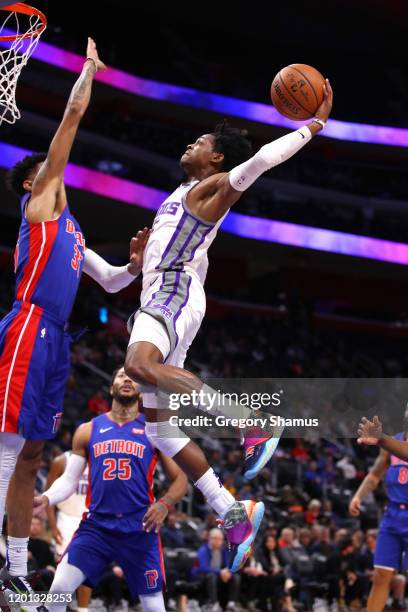 De'Aaron Fox of the Sacramento Kings drives to the basket against Christian Wood of the Detroit Pistons during the first half at Little Caesars Arena...