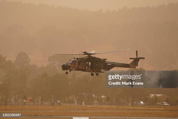 An Army helicopter lands at Canberra Airport amidst bushfire smoke on January 23, 2020 in Canberra, Australia. The fire on Kallaroo road in Pialligo...