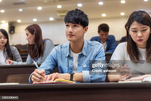 university student paying attention in class - escritura japonesa imagens e fotografias de stock