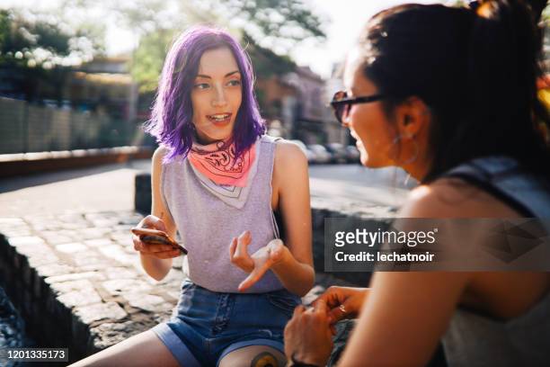 Two girls having a discussion in the street