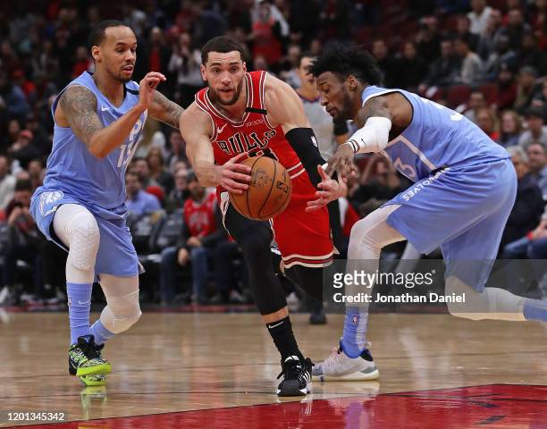 Robert Covington of the Minnesota Timberwolves knocks the ball away from Zach LaVine of the Chicago Bulls as he drives past Shabazz Napier at the...