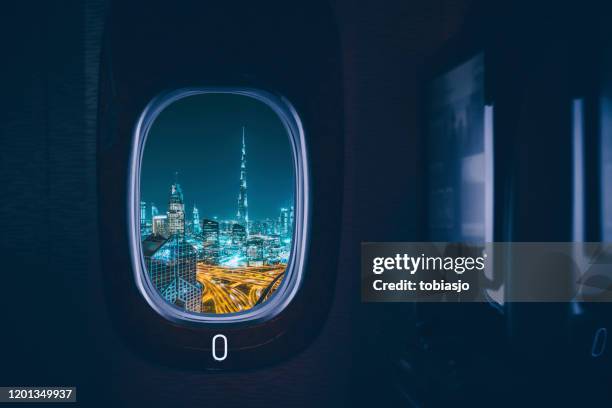 dubai seen through the window of an airplane - united arab emirates night stock pictures, royalty-free photos & images