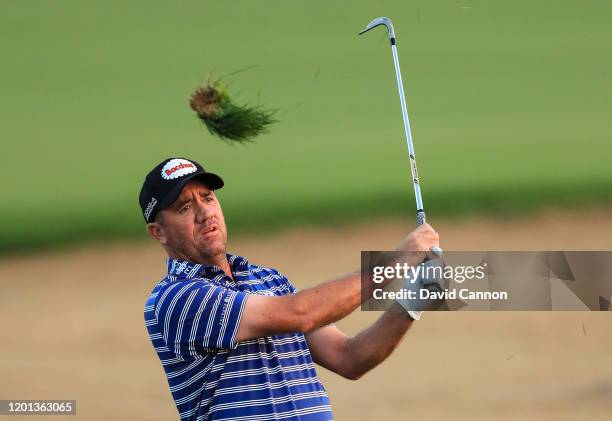 Scott Hend of Australia plays his second shot on the 10th hole from the thick rough during the first round of the Omega Dubai Desert Classic on the...