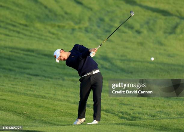 Jazz Janewattananond of Thailand plays his second shot on the 10th hole during the first round of the Omega Dubai Desert Classic on the Majlis Course...