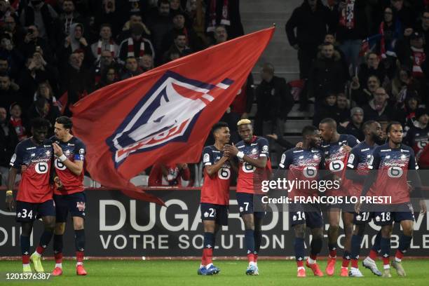 Lille's Nigerian forward Victor Osimhen is congratuled by teammates after scoring a goal during the French L1 football match between Lille LOSC and...