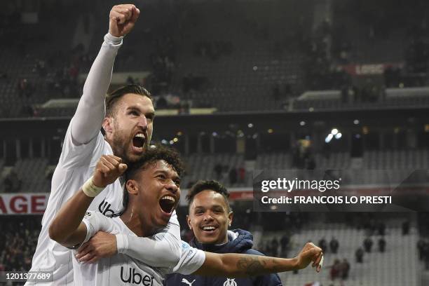 Marseille's French defender Boubacar Kamara and Marseille's Dutch midfielder Kevin Strootman celebrate after winning the French L1 football match...