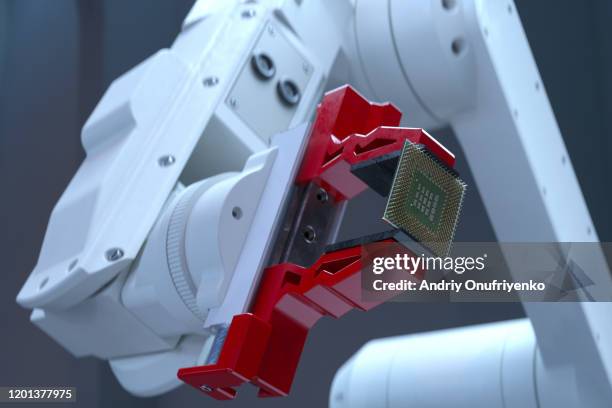 robotic arm holding processor - chip fabrik stock-fotos und bilder