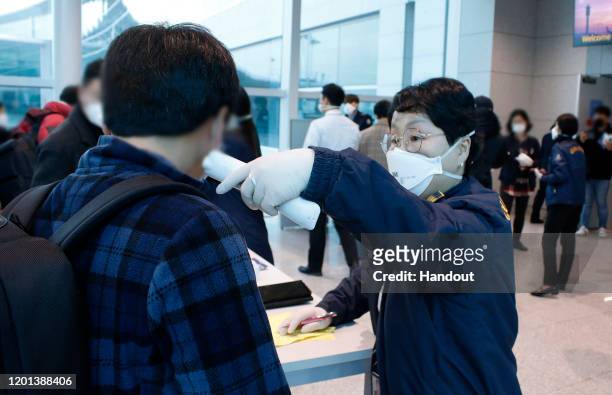 In this handout image provided by Korea Centers for Disease Control and Prevention and photo taken on January 22 South Korean quarantine officer...