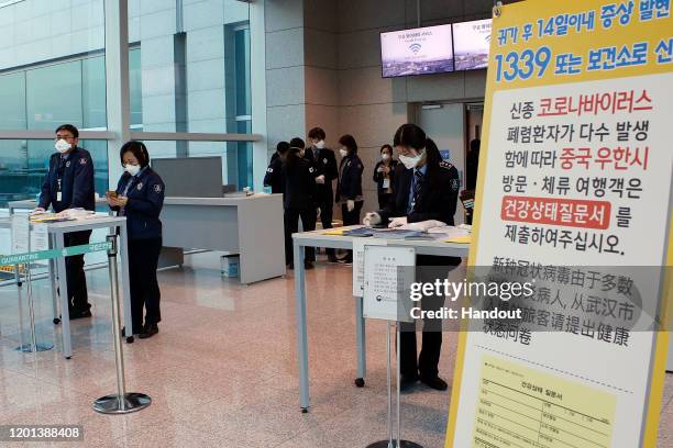 In this handout image provided by Korea Centers for Disease Control and Prevention and photo taken on January 22 South Korean quarantine officer wait...