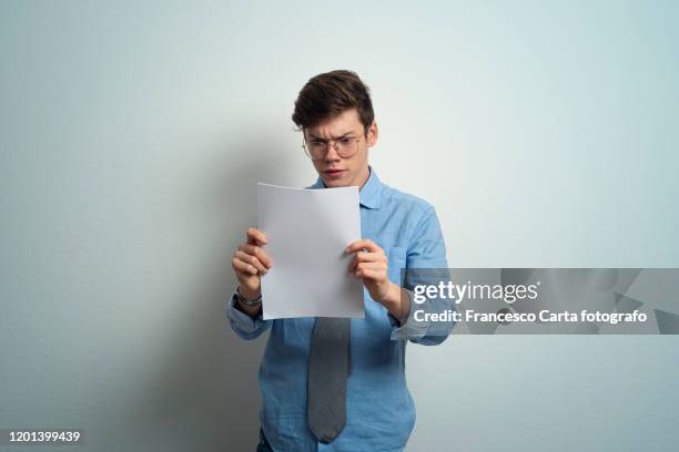 man looking over some paperwork - carta documento stock pictures, royalty-free photos & images