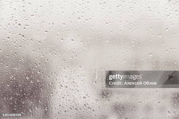 water droplets on glass, humidity and foggy blank. bad weather, rain - luchtvochtigheid stockfoto's en -beelden