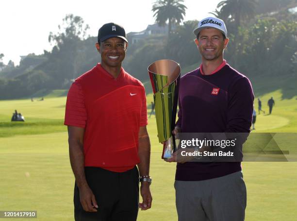 Adam Scott of Australia poses with tournament host Tiger Woods and the trophy after winning the the Genesis Invitational at Riviera Country Club on...
