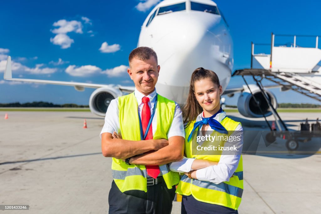 Airport service team in front of airplane