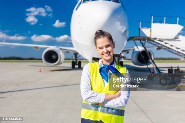 airport service young woman in front of airplane - crew stock pictures, royalty-free photos & images