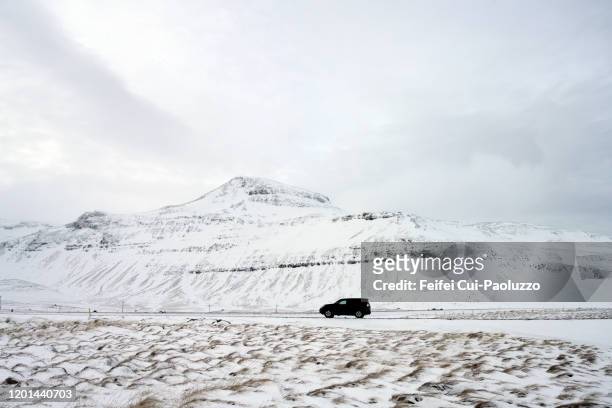 a car on the dirt road of berg, western region, iceland - snow on grass stock pictures, royalty-free photos & images