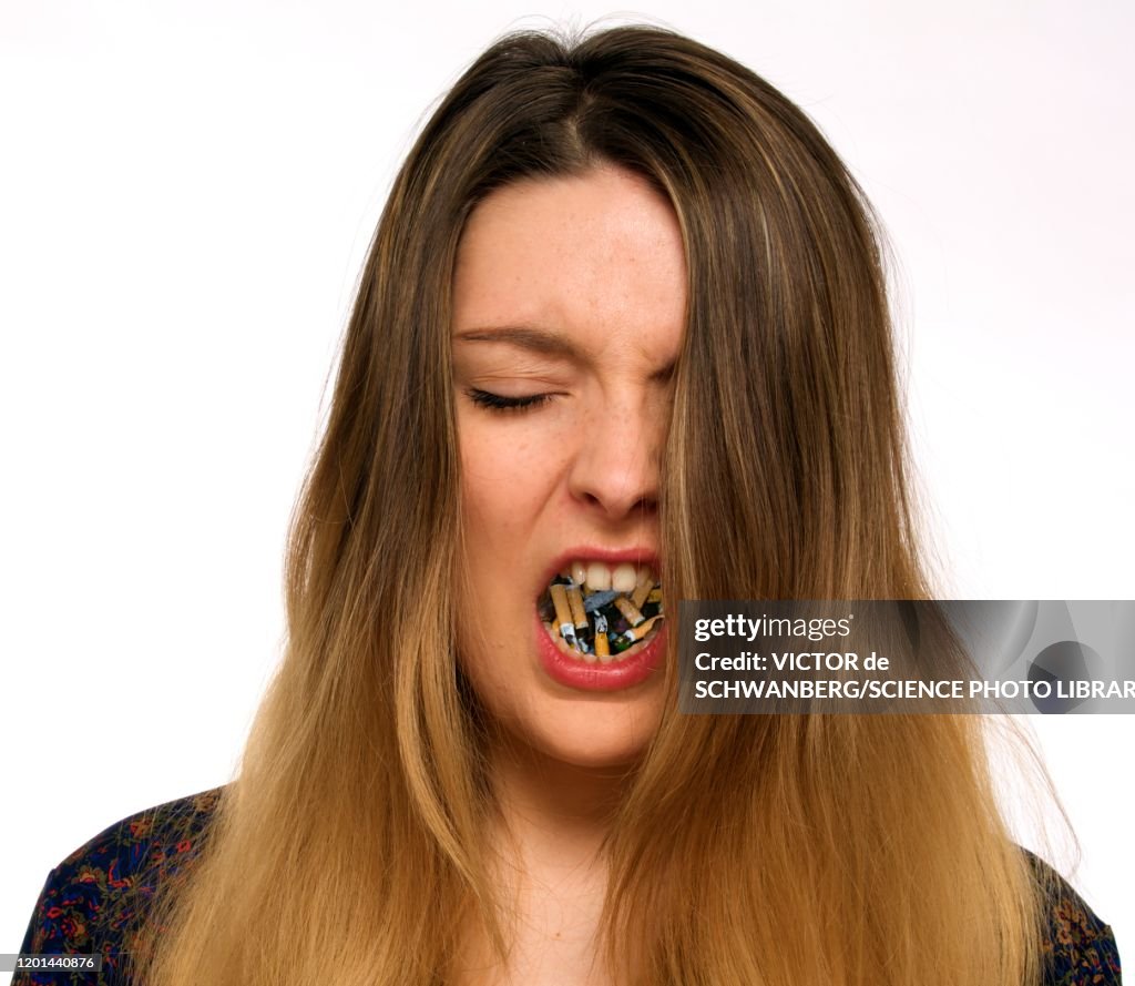 Woman with cigarettes in mouth