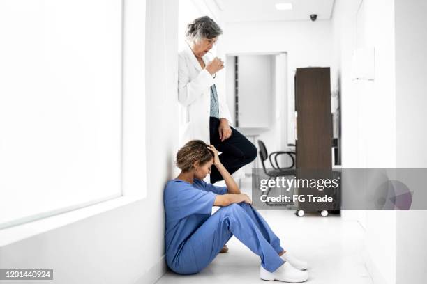 upset female doctors at hospital - medical mistake stock pictures, royalty-free photos & images