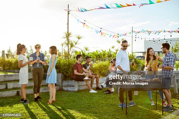 people enjoying asado party at backyard - barbecue social gathering stock pictures, royalty-free photos & images