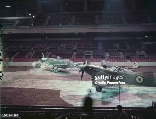 Two Royal Air Force Supermarine Spitfire fighter aircraft are prepared for inclusion in the 1957 Royal Tournament military tattoo at Earls Court...