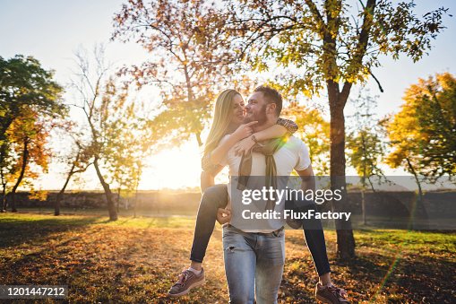 Couple Back Ride Playful Romantic Couple Piggyback Riding At A Park High-Res Stock Photo ...