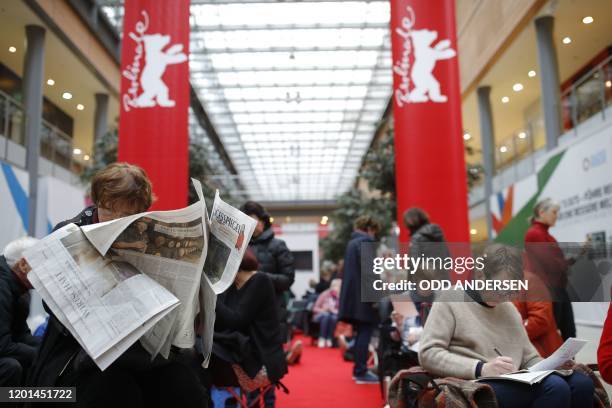 People queue as they wait for the 70th Berlinale film festival tickets to go on sale at the Potsdamer Arkaden mall in Berlin on February 17, 2020. -...