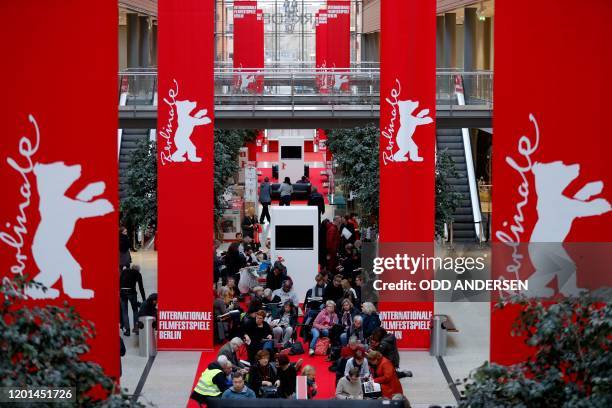 People queue as they wait for the 70th Berlinale film festival tickets to go on sale at the Potsdamer Arkaden mall in Berlin on February 17, 2020. -...