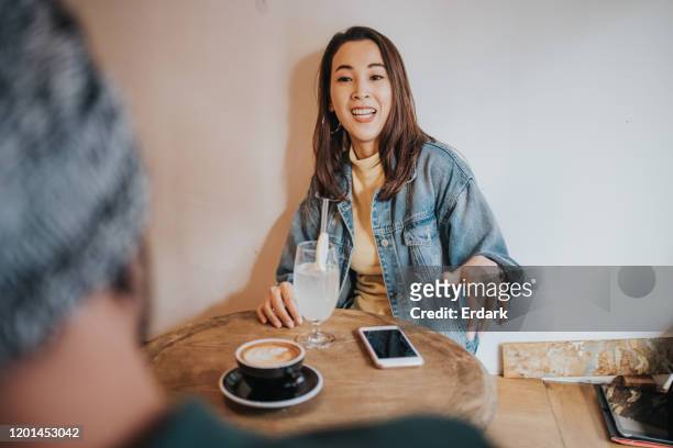 hipster couple resting at the coffee shop - hipster coffee shop candid stock pictures, royalty-free photos & images