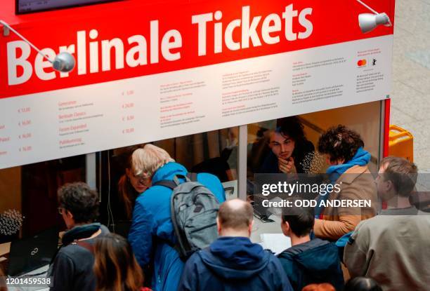 People queue to buy tickets for the 70th Berlinale film festival as the sale starts at the Potsdamer Arkaden mall in Berlin on February 17, 2020. -...