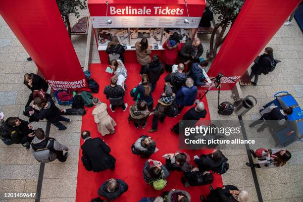 February 2020, Berlin: Film lovers are standing at one of the ticket booths in the Potsdamer Platz Arkaden to buy tickets for the International Film...
