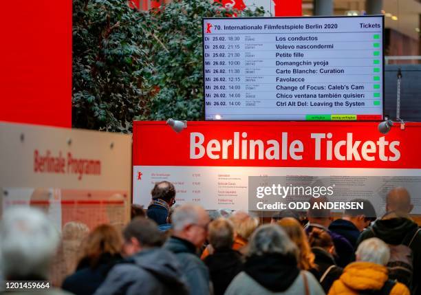 Festival goers queue for tickets for the 70th Berlinale film festival as the sale starts at the Potsdamer Arkaden mall in Berlin on February 17,...