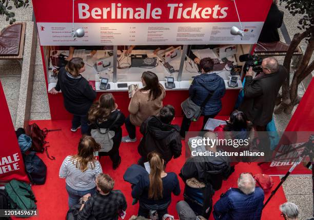 February 2020, Berlin: Film lovers are standing at one of the ticket booths with the words "Berlinale Tickets" in the Potsdamer Platz Arkaden to buy...