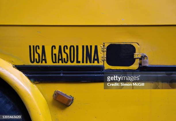 'usa gasolina' (use gasoline) sign painted on beside the fuel tank cap on a yellow school bus - gasolina stock pictures, royalty-free photos & images