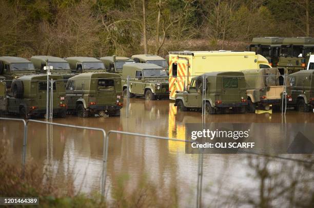 Picture shows a flooded car park with out of service military Landrovers parked in flood water in Leominster in western England, on February 17 after...