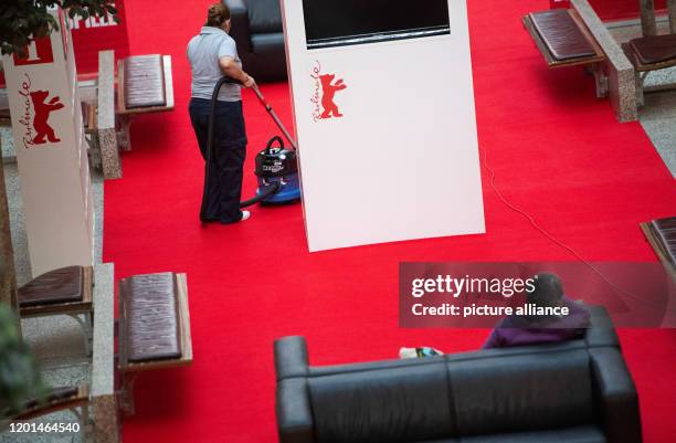 February 2020, Berlin: A woman sucks a red carpet in the Potsdamer Platz Arkaden, where tickets for the International Film Festival "Berlinale" are...