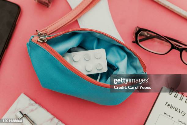 menstrual tampons and pads in cosmetic bag. menstruation time. hygiene and protection - pm fotografías e imágenes de stock