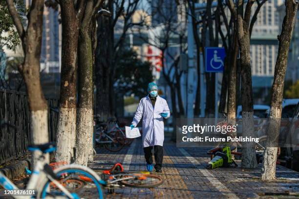 Doctor walks to a hospital in Wuhan in central China's Hubei province Sunday, Feb. 16, 2020.- PHOTOGRAPH BY Feature China / Future Publishing