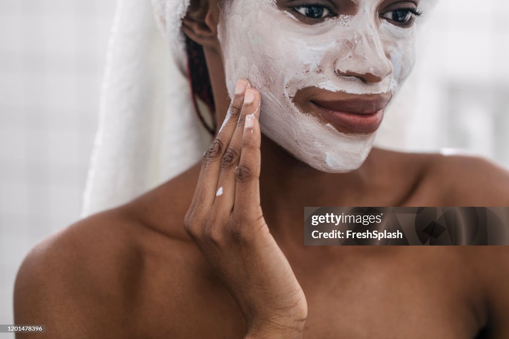 Woman Applying Cosmetic Face Mask