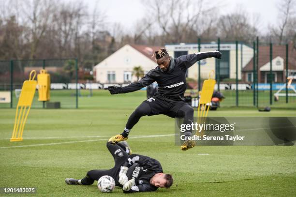 Goalkeeper Rob Elliot dives to make a save from teammate Allan Saint-Maximin during the Newcastle United Training Session at the Newcastle United...