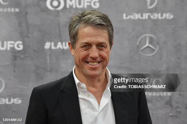 English actor Hugh Grant poses on the red carpet prior to the 2020 Laureus World Sports Awards ceremony in Berlin on February 17, 2020.