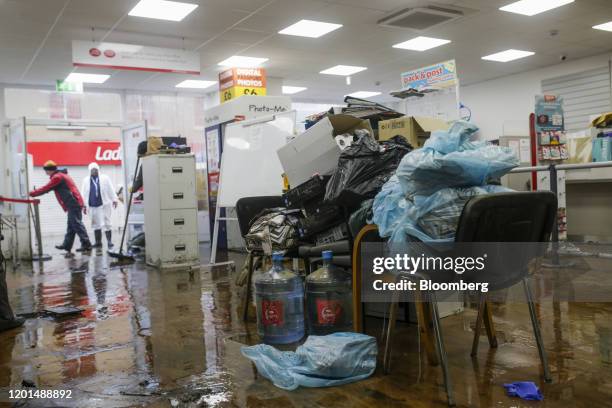 Damaged shop fittings and furniture sit on chairs to keep them out of the flood water in the center of a post office in Pontypridd, U.K., on Monday,...