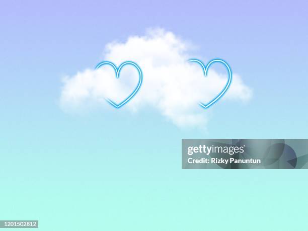 two neon heart light between the clouds in sky - neon sign foto e immagini stock