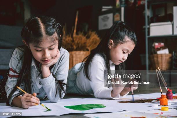 Close up of childern painting together
