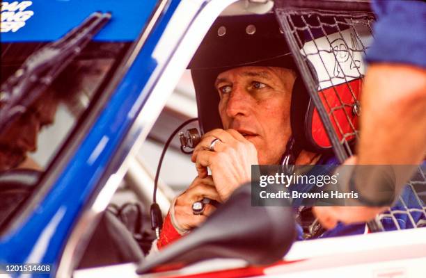 American actor and race car driver Paul Newman in his car during an inspection at Lime Rock Race Track, Lakeville, Connecticut, 1985.