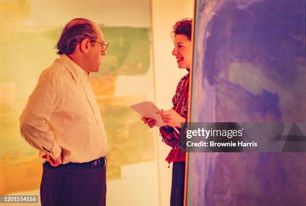 German-born American art dealer and gallery owner Andre Emmerich listens to American abstract expressionist artist Helen Frankenthaler , New York,...