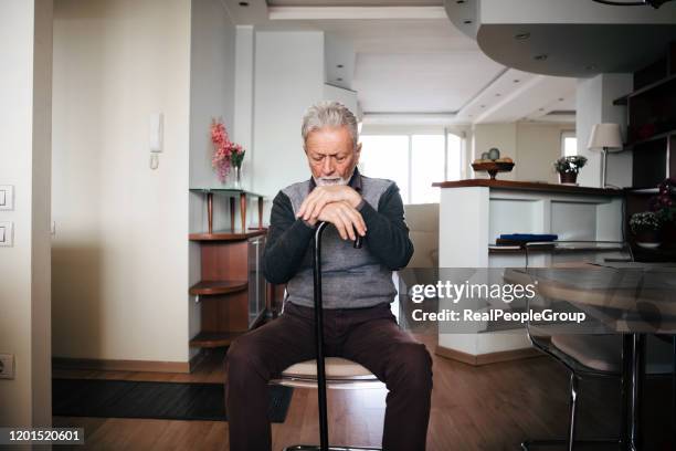 elderly man sitting alone at home - widow pension stock pictures, royalty-free photos & images