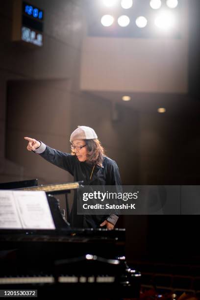 musical conductor in concert hall - choir stage stock pictures, royalty-free photos & images