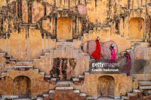 indian women carrying water from stepwell near jaipur - rajasthani women stock pictures, royalty-free photos & images