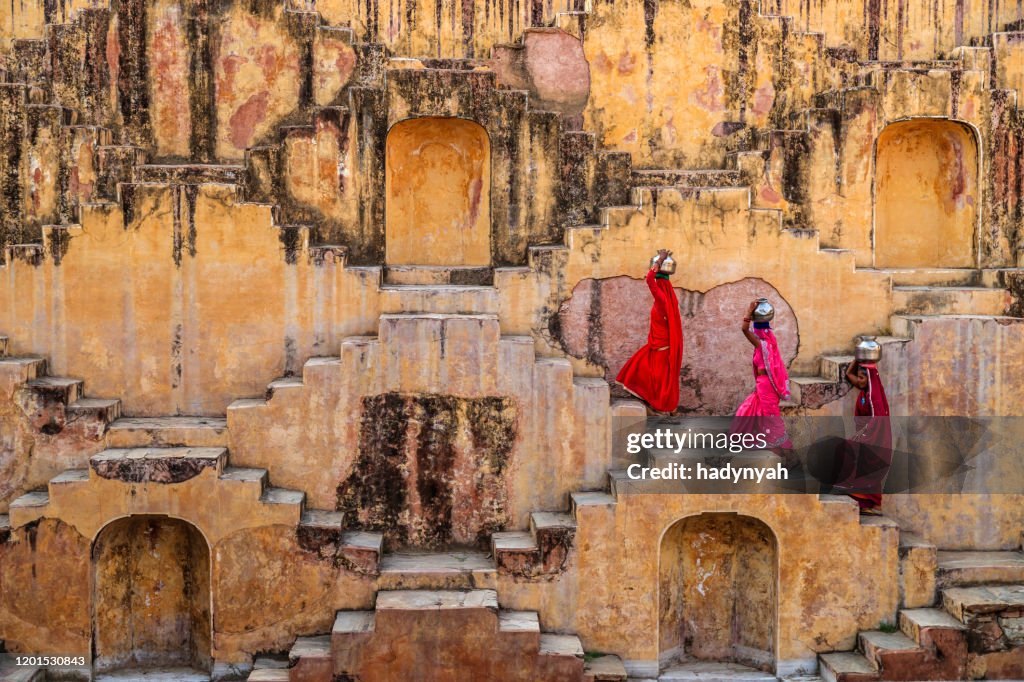 Indian women carrying water from stepwell near Jaipur