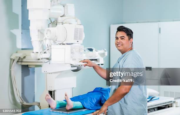 technologist taking x-ray of girl's foot - radiographer stock pictures, royalty-free photos & images