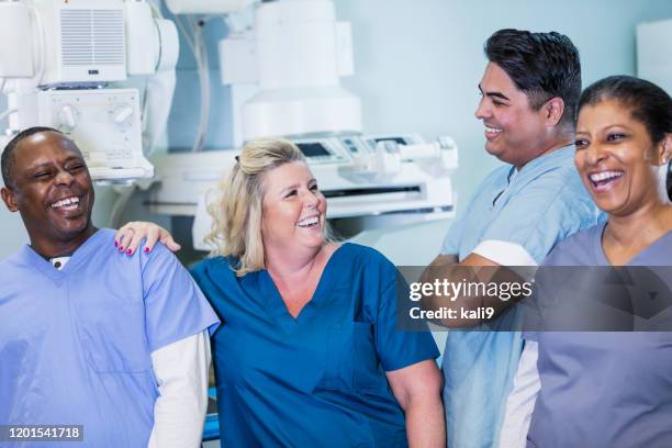 technologists with x-ray equipment - radiographer stock pictures, royalty-free photos & images